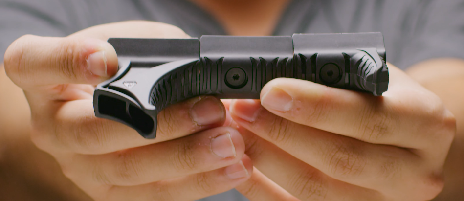 This close up shot shows the complete strike industries hand stop kit, featuring the textured forward grip and the universal LINK mounting hardware designed for tactical rifles.
