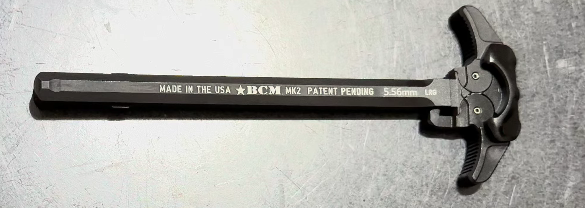 A high-detail, close-up shot of the BCM MK2 ar charging handle, showcasing the extended textured latches designed for a more reliable grip and smoother operation.