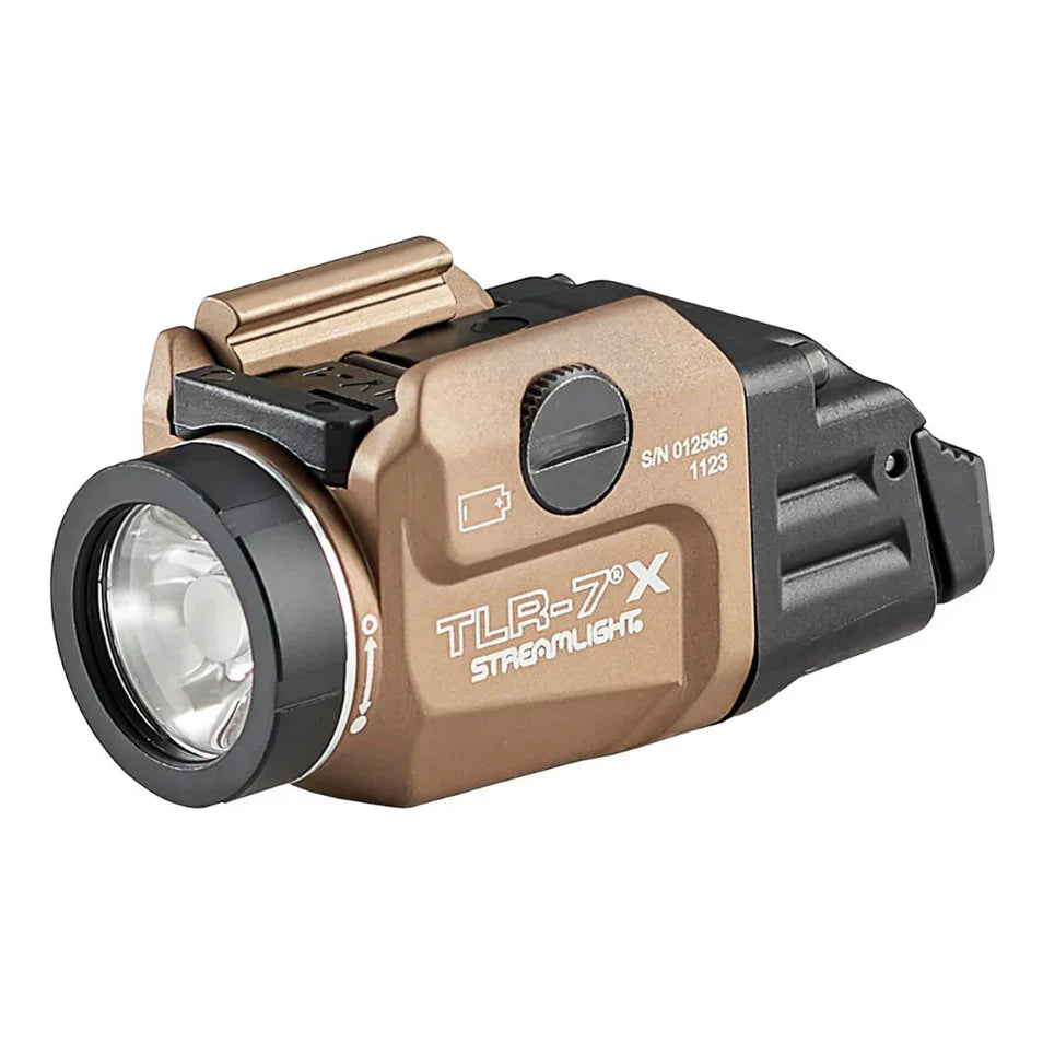 Close-up side profile of a streamlight fde pistol light, specifically the compact TLR-7X model, featuring a flat dark earth body, black lens bezel, and rail mounting system.
