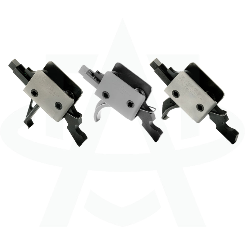 A close-up comparison of three single-stage ar 15 fire control group triggers, showing a flat blade, a standard curved bow, and a curved combat trigger from left to right.