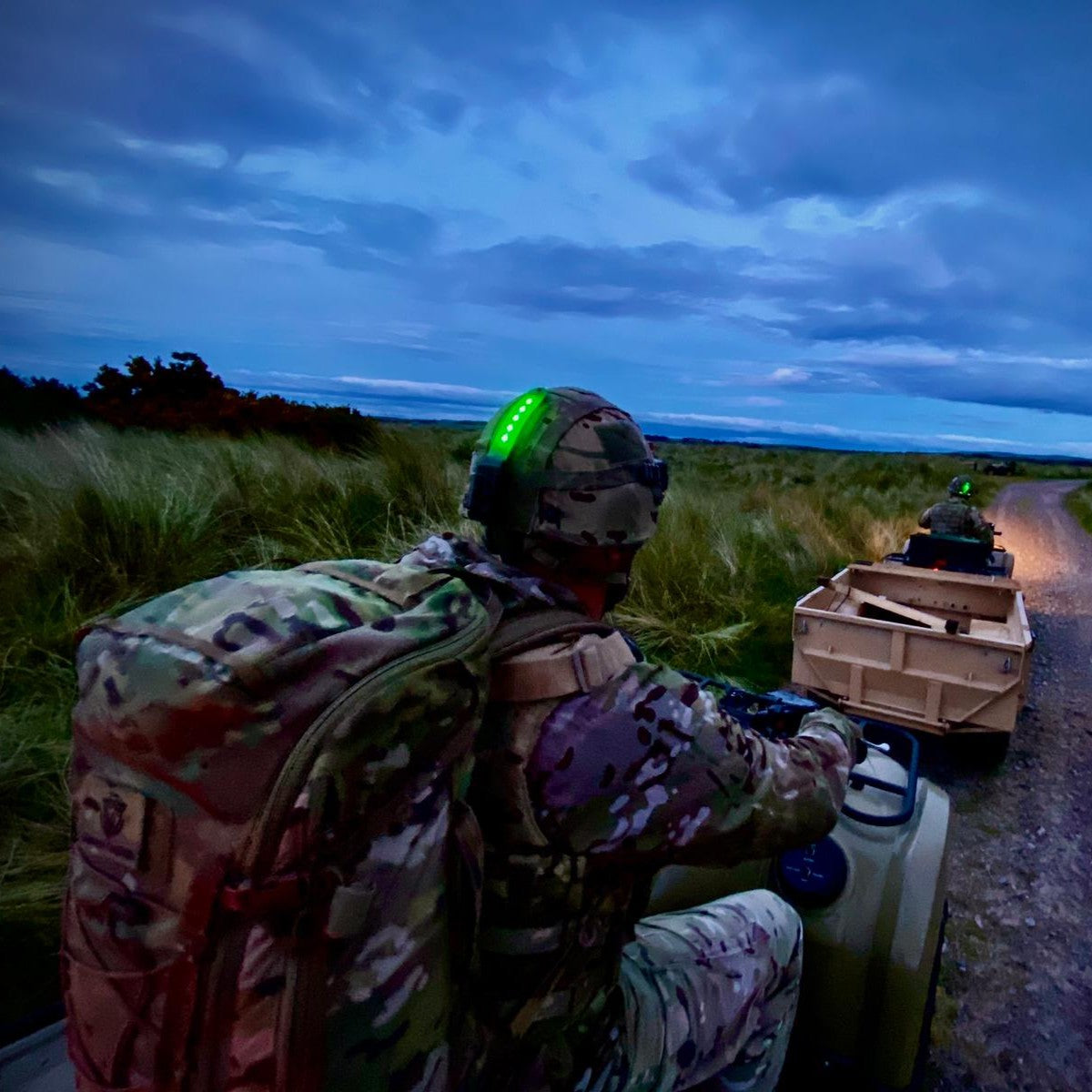 Squad of operators using the HEL-STAR 5 EXO while driving ATVs.