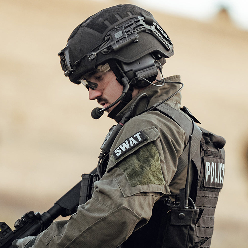 a left side view of a swat officer wearing black full cut hellbender te helmet