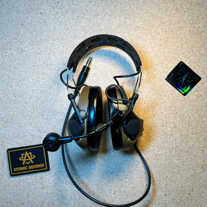 A 3M Peltor ComTac VIII communication headset displayed from its interior side, showing the padded leather headband cushioning and deep contour ear cup linings engineered for tactical comms isolation.