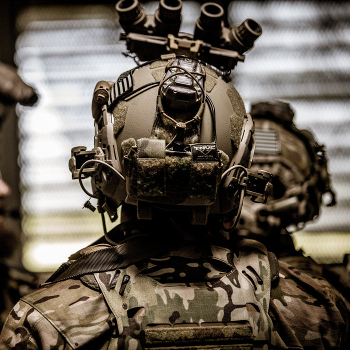 An operator wearing a CORE Survival HEL-STAR 6 Gen III on a FAST SF Gen 2 helmet with an L3 GPNVG-18.