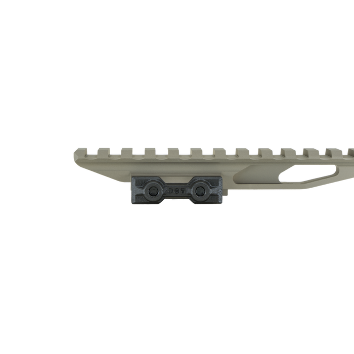 the image showcases the DOT DORM EXT in the color FDE or flat dark earth and is on a side view that features the clamp in which the mount will be attached to the rifle of the user./