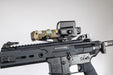 the image shows us the DORM EXT in the color black and is attached on a noveske rifle where the extension mount is clamped on top of it and what looks to be a holographic sight is also on top of the mount. 