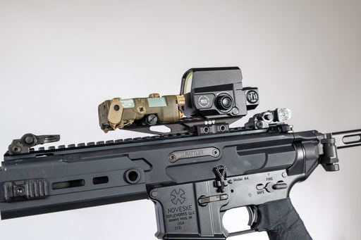 the image shows us the DORM EXT in the color black and is attached on a noveske rifle where the extension mount is clamped on top of it and what looks to be a holographic sight is also on top of the mount. 