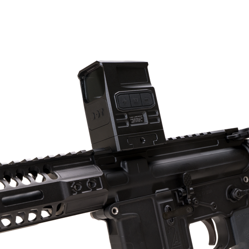 the image showcases the DOT EHS-1 L Holographic Sight in the color black and is being attached directly on a black rifle where the rifle is tilted slightly downwards and we can see the adjustment dials on the left side of the holographic sight. 