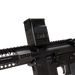 the image showcases the DOT EHS-1 L Holographic Sight in the color black and is being attached directly on a black rifle where the rifle is tilted slightly downwards and we can see the adjustment dials on the left side of the holographic sight. 