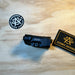 The Holosun IRIS GR3 in the color Black and is being featured on its side view where you can see the product name and its code brande don it, with an atomic patch on each side of the item