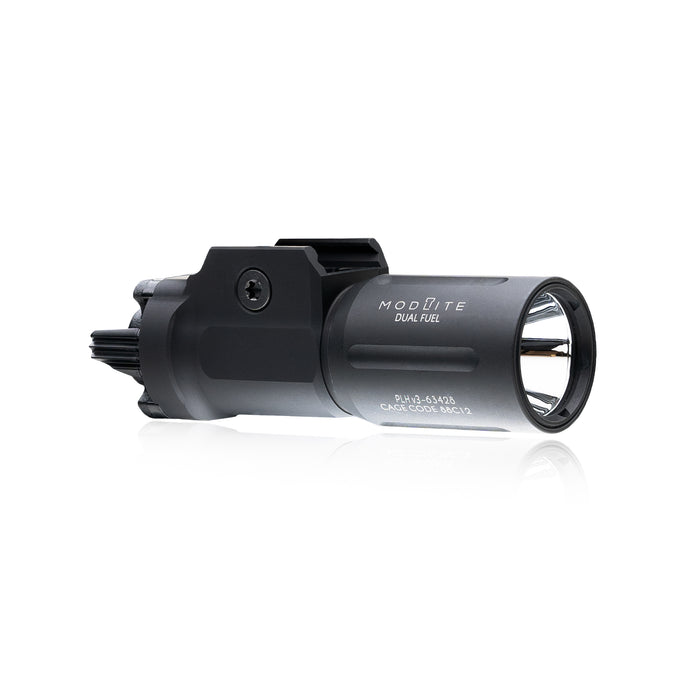 an image of the PL350 in the color black and has the PLHv3 light head where it is angled that you can see the right side of the item where the brand name and the words "dual fuel" is branded on it in white and we can see the attachment partition that attaches this light on a pistol.