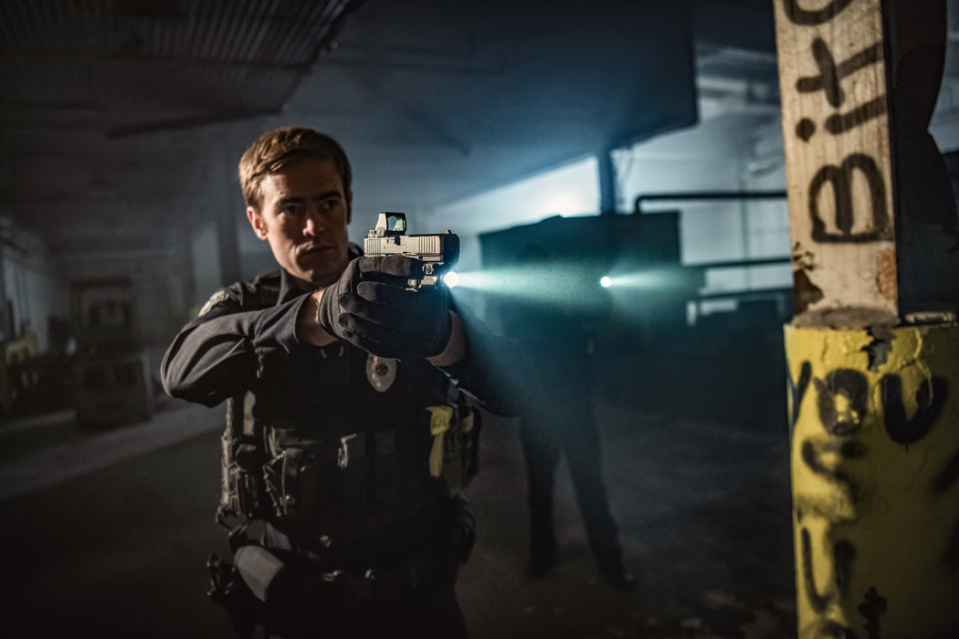 the surefire xc3-b weapon light that is being attached on a pistol and being utilized in a night operation