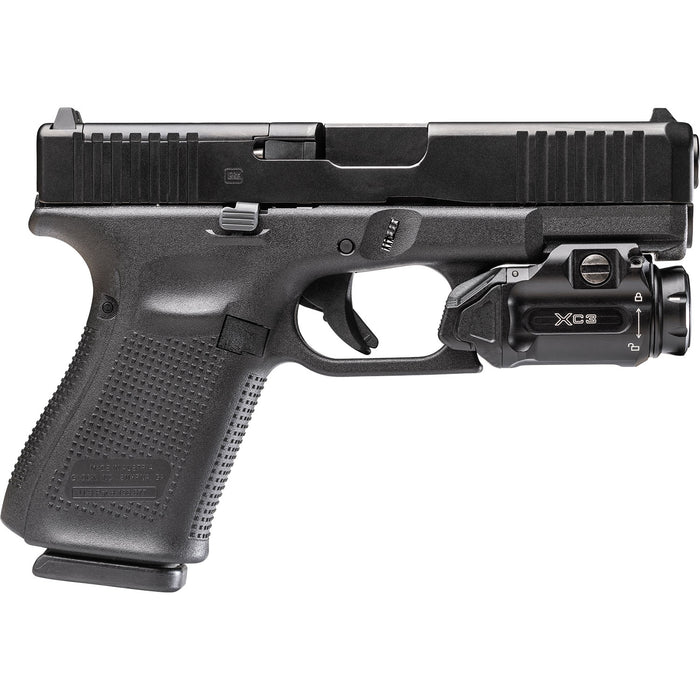 The Surefire XC3-B weapon light on a side view and has been mounted on a Glock 19 pistol