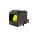 an isometric product photo of the Trijicon RCR Red Dot Sight against a plain white background and prominently featured at the front-left, reflecting a dramatic green and orange dichroic coating and showing small white laser-engraved markings are visible along the base on the right side: 'MADE IN USA PATENT PEND', with the small Trijicon 'Tri' triangle logo above it.
