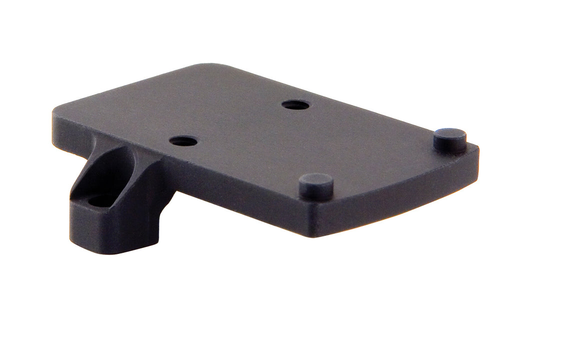 a product image of the trijicon rmr footprint mount in its isometric view featuring a small, flat, rectangular platform featuring four distinct protrusions that are two round recoil pins and two thread screw holes and in the color black.