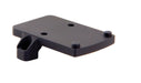a product image of the trijicon rmr footprint mount in its isometric view featuring a small, flat, rectangular platform featuring four distinct protrusions that are two round recoil pins and two thread screw holes and in the color black.