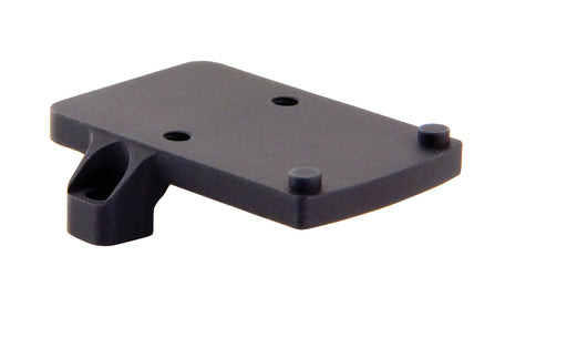 a product image of the trijicon rmr footprint mount in its isometric view featuring a small, flat, rectangular platform featuring four distinct protrusions that are two round recoil pins and two thread screw holes and in the color black.