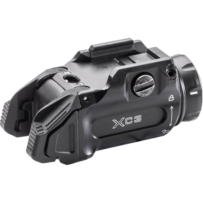 The Surefire XC3-B weapon light presented in a rear angle view that shows part of the left side that has the product name and the locking instruction branded on to it and the slope ridge of the back part of the weapon light that allows it to fit well on the underside of a pistol