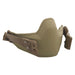 A close-up front view of the Galvion Caiman Mandible in the color Tan 499, showing the smooth outer shield and protective profile.