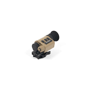 A frontal angled view of the tan Nocpix H25 Thermal Weapon Sight, showing its black rubber eyecup, closed objective lens cover, top control buttons, and the black quick-detach mounting base.