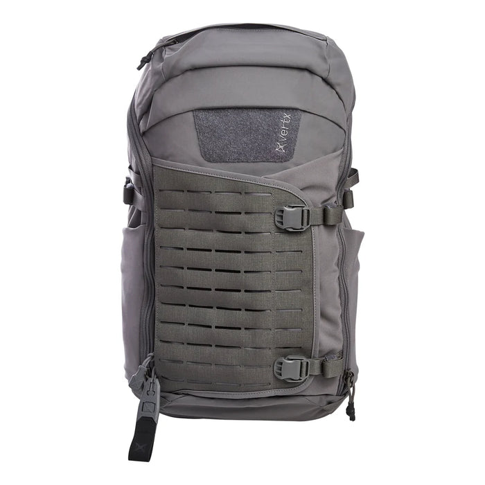 A frontal view of the Vertx Siege 25L tactical backpack in Wolf Grey highlights the expandable front pouch and laser-cut MOLLE panel.