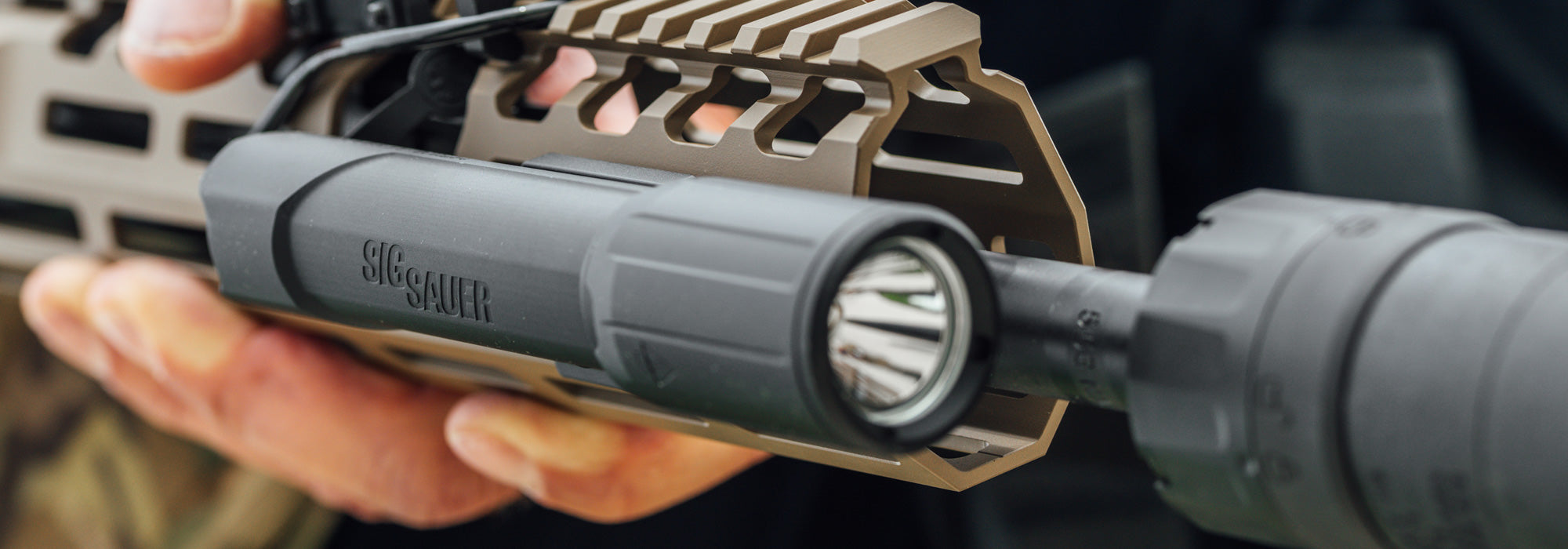 A left angled view of the Sig Foxtrot MSR Rifle Mounted White Light attached to an AR-15 rifle, showing how it mounts securely to the handguard.