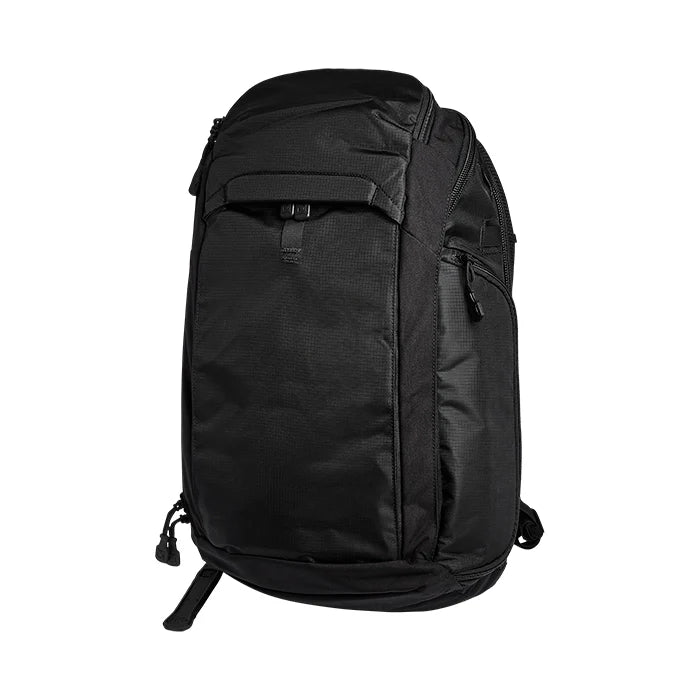 A side-angled shot of the black Vertx Gamut CCW Tactical Backpack displaying its low-profile depth and zipper arrangement.