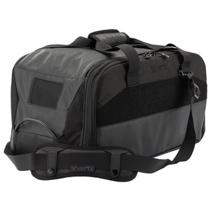 A side-angled shot of the vertx heavy range bag showing the durable padded shoulder strap in the foreground and the side caddie compartment situated in the second plane.
