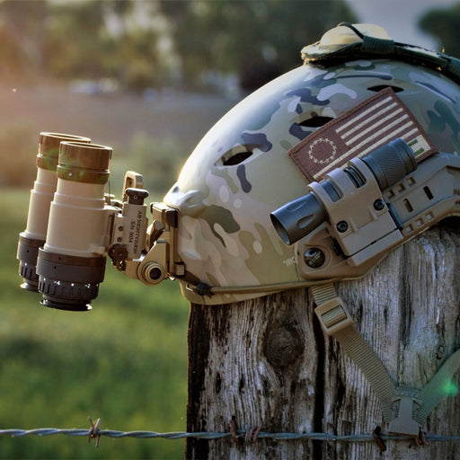 A side profile of the Flat Dark Earth rnvgs securely attached to an Ops-Core FAST Bump helmet via a Wilcox G24 mount.