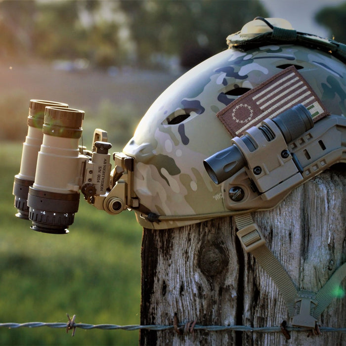 A side profile of the Flat Dark Earth rnvgs securely attached to an Ops-Core FAST Bump helmet via a Wilcox G24 mount.