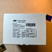 A side-by-side view of a cardboard product box for a tactical headset showing its manufacturing details, certifications, and complete product specifications printed clearly on the outer packaging.