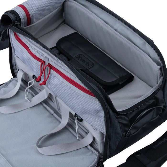 An aerial top-down view of the vertx cof range bag with the main and side compartments fully opened to reveal the internal dividers and storage capacity.