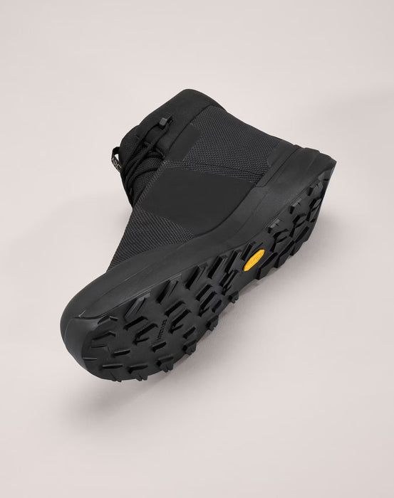 the arc'teryx kopec mid gtx in the black variant and is placed down on its side showing the the left view and a portion of the textured sole.