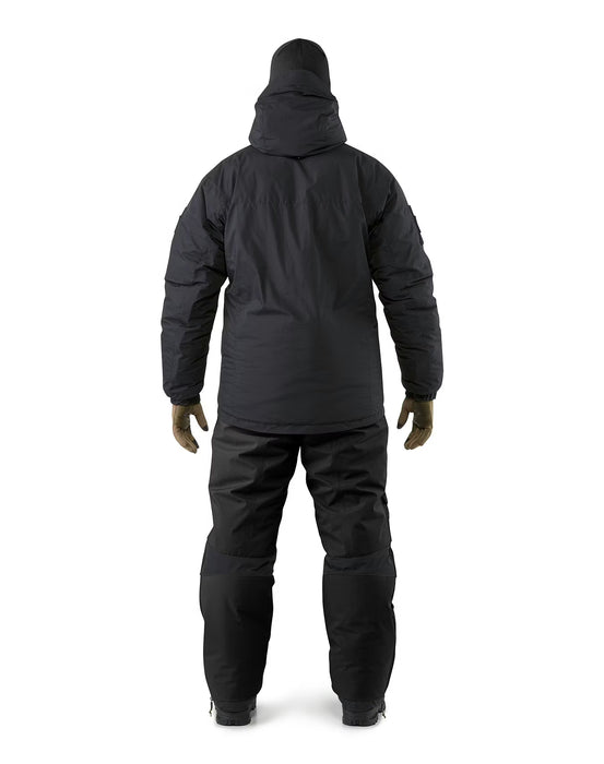 Back view of a person wearing the black Arcteryx Pro Cold WX Jacket SV designed for Special Reconnaissance missions, showcasing the reinforced shoulders, insulated pants, and a clean tactical profile for low-visibility operations.