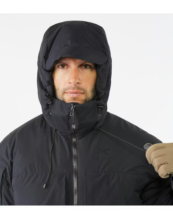 Close-up view of the adjustable hood on the black Arcteryx jacket, featuring high-performance Coreloft synthetic insulation designed to trap heat around the face and neck during sub-zero operations.