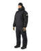 Full body side view of a person wearing the black Arcteryx wet weather jacket and matching insulated pants, featuring a tactical flag patch on the arm and a protective hood for severe storms.