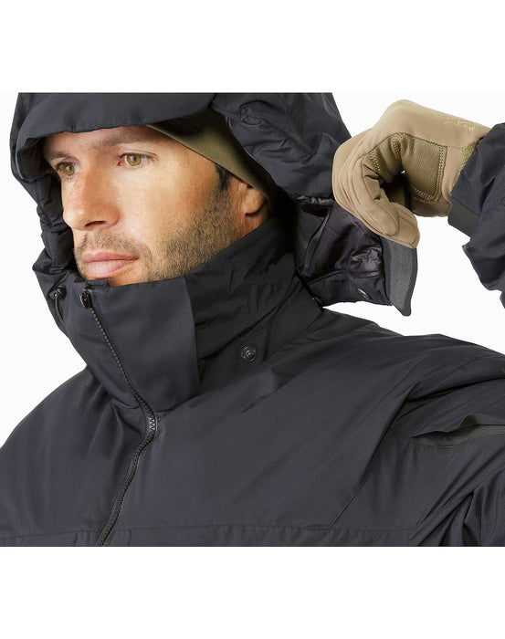 A photo showing the black windproof hooded jacket with the insulated hood detached, highlighting the clean collar design and the heavy-duty zipper system meant for high-performance use.