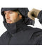 A photo showing the black windproof hooded jacket with the insulated hood detached, highlighting the clean collar design and the heavy-duty zipper system meant for high-performance use.