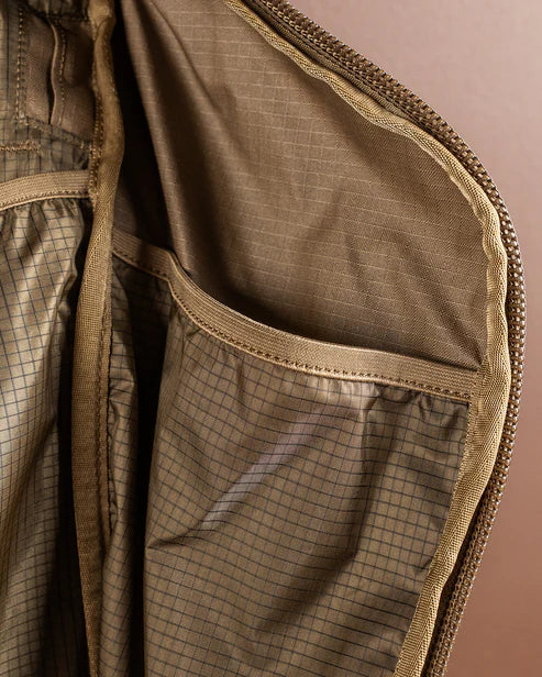 A detailed close-up shot showing the interior of the Eberlestock Brute 3500 Multi-Day Pack side pocket, featuring high-quality mesh fabric that keeps smaller tools and hunting essentials organized and easy to see.