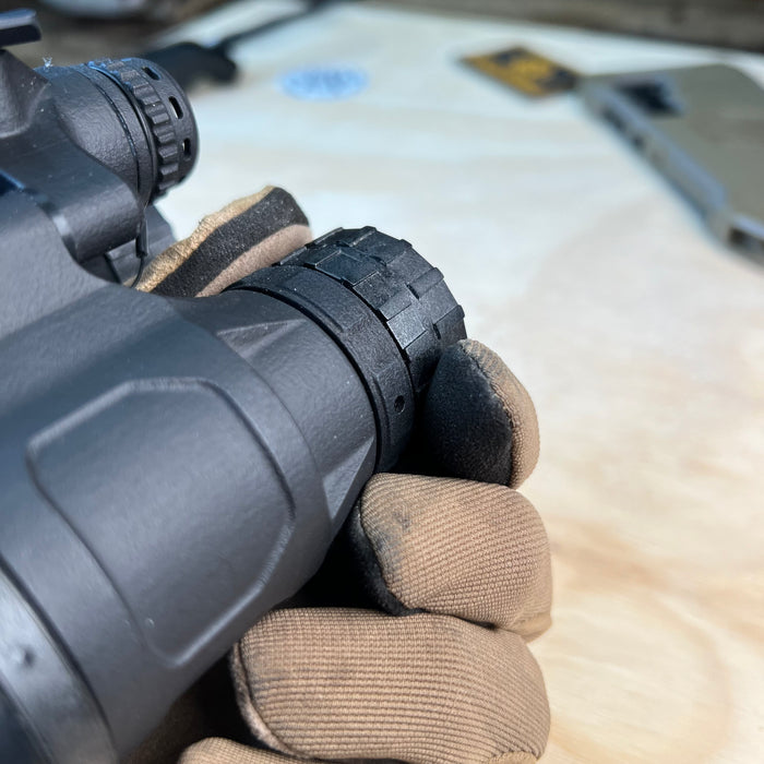 A high-detail close-up shot focusing on the textured black matte finish of the katana nvg housing, showcasing its rugged, non-reflective surface and precision injection-molded design.