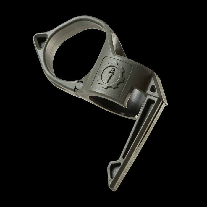 close up of a sage green switchback ring against a black background