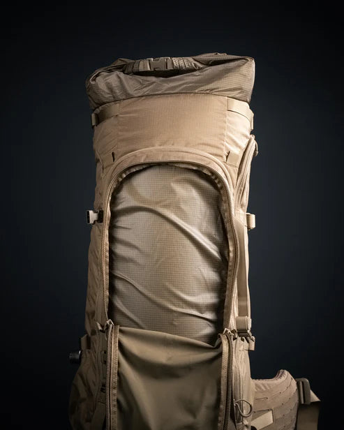 A close-up view of the external frontal pouch on the Eberlestock Brute 6500 Tactical Pack, showing the rugged storage space designed for quick-access gear and mission-critical supplies.