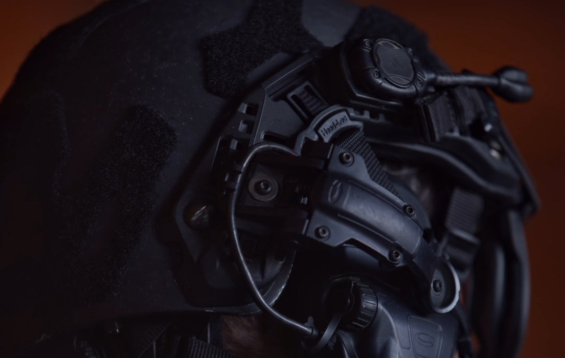 Close-up shot of the ops core fast xp 2.0 in black, featuring PowerPath ARC rails with a Princeton Tec light on the top rail and vented Ops-Core arms attached to Comtac VIIIs, all in matching black