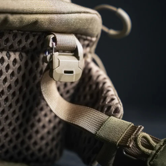 A close-up detail of the durable quick-release buckle and nylon strap connecting to the breathable air-mesh back panel, a common feature on modular eberlestock packs.