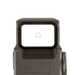 A close-up view through the rear window of the flat dark earth DOT EHS-1, showcasing the bright 1 MOA dot 65 MOA ring reticle used for fast and precise aiming.