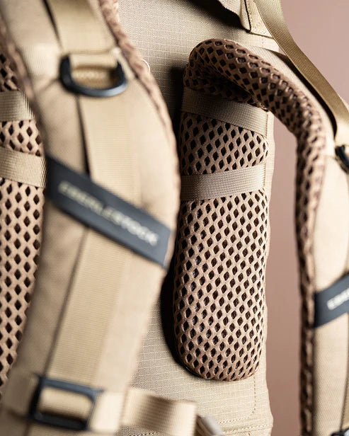 A close-up shot of the F1 Mainframe Pack contour shoulder straps, displaying the breathable mesh lining and thick padding designed for maximum airflow and comfort.