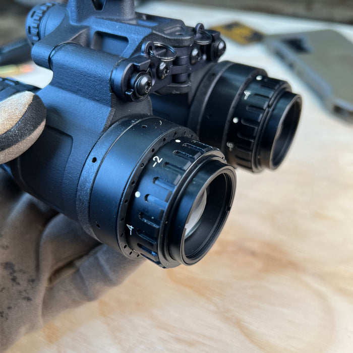 A detailed close-up shot captures the clarity and specialized coating of the front objective lens on a nocturne katana, highlighting the precision glass optics that allow light into the system.