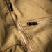 A close-up view of the Eberlestock Deadwood Trousers focusing on the front utility pocket and the two-way side vent zippers used for cooling during high-output activity.