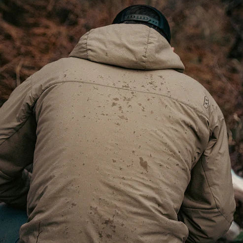 Close-up view of the back of the Eberlestock Alturas Hooded Jacket repelling rain.