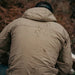 Close-up view of the back of the Eberlestock Alturas Hooded Jacket repelling rain.